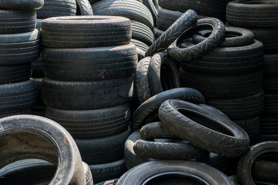 Old used tires stacked with high piles
